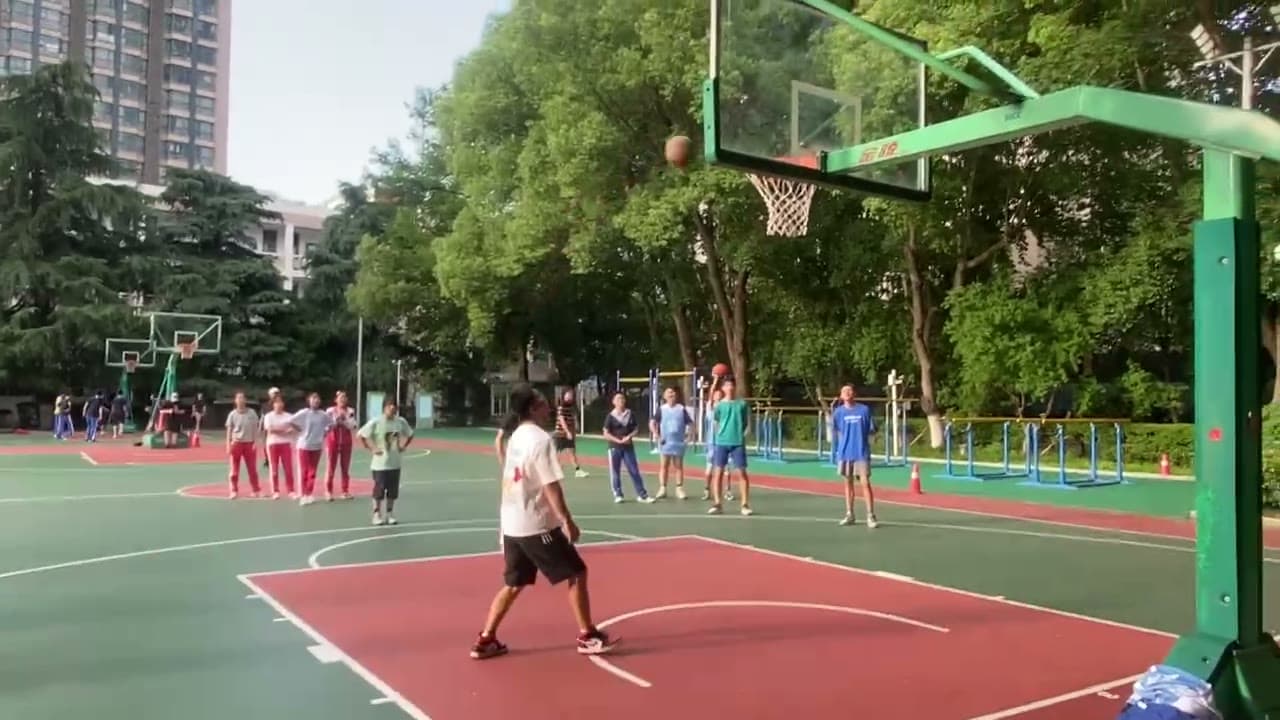 Video still of a free throw on the outdoor basketball court, dated June 1, 2023.